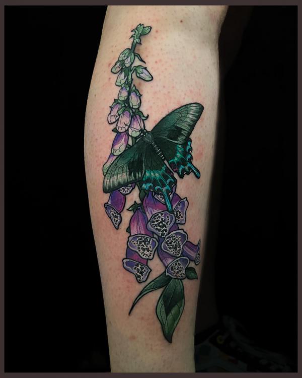 Foxglove and butterfly tattoo on forearm