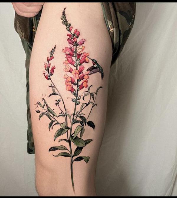 Foxglove and hummingbird thigh tattoo