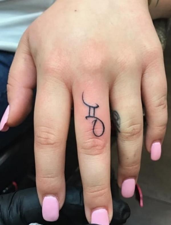 Gemini glyph finger tattoo
