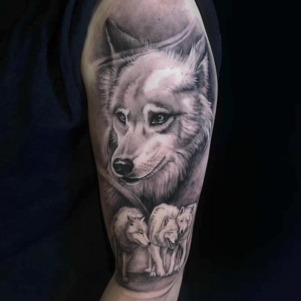 Gray Wash wolf family tattoo on upper arm