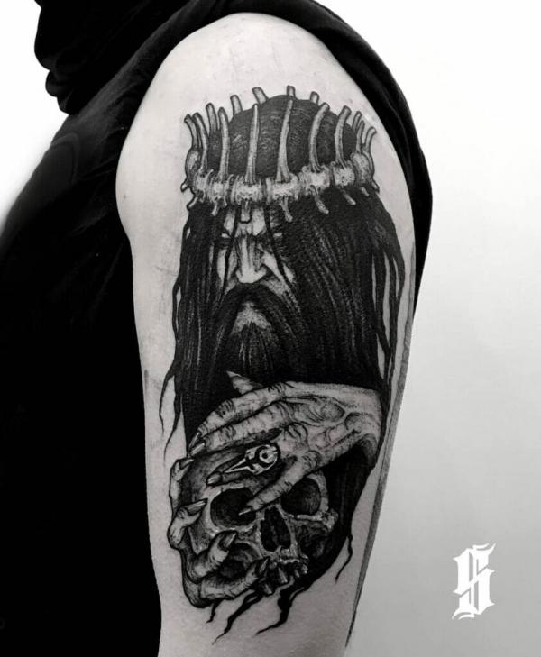 Hades and skull tattoo on upper arm