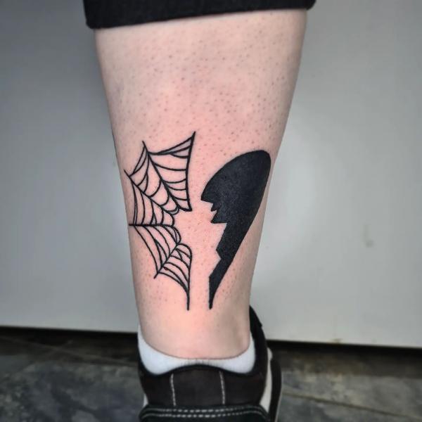 Half broken heart half spider web tattoo