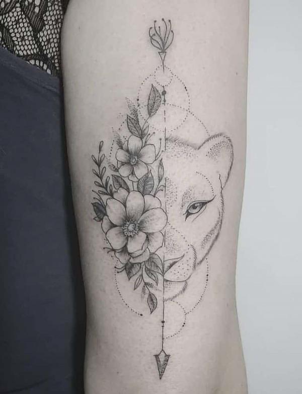 Half flower Half lioness face back of arm tattoo