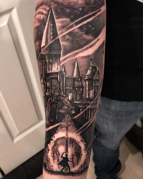 Hogwarts School and deathly hallows forearm tattoo