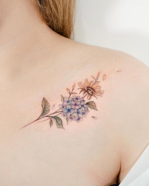 Hydrangea and daisy collarbone tattoo