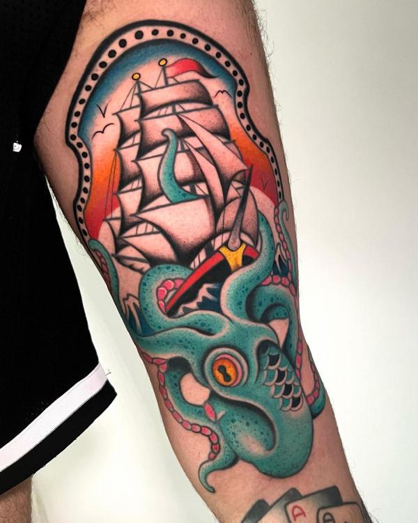 Kraken and ship upper arm tattoo traditional