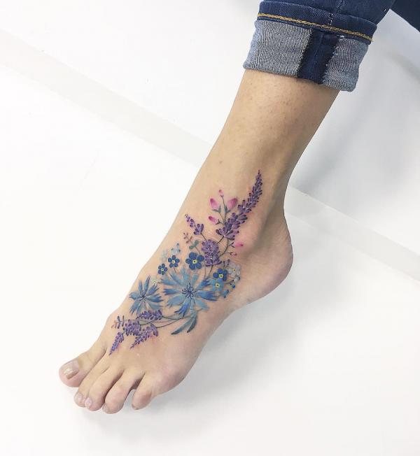 Lavender and aster flower foot tattoo