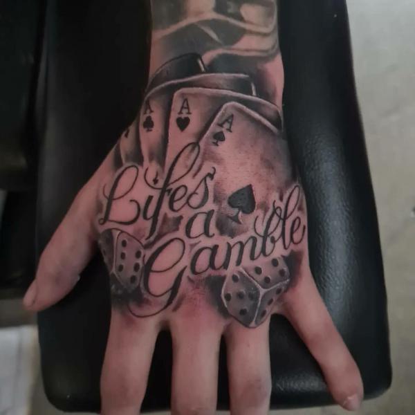 Lifes a gamble with dice and cards tattoo on hand