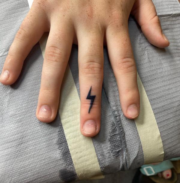 Lightning bolt finger tattoo