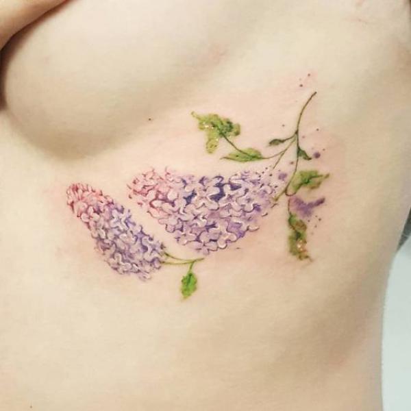 Lilac flower side boob tattoo
