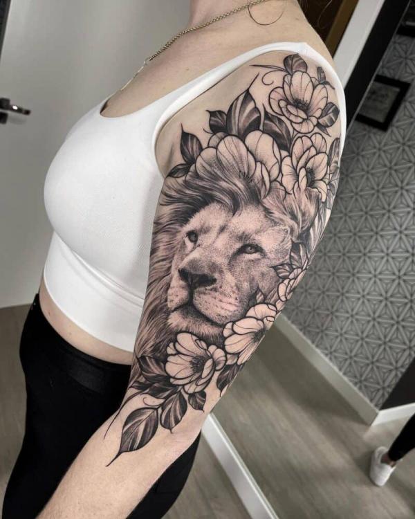 Lion with flowers tattoo half sleeve