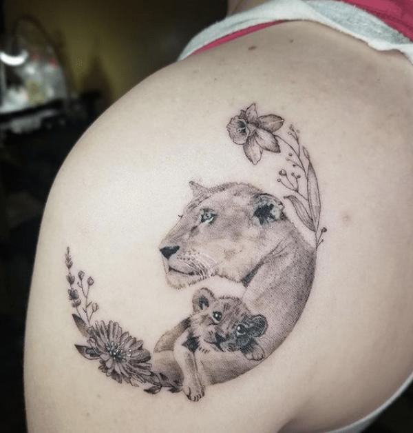 Lioness and cub floral crescent moon tattoo on shoulder blade