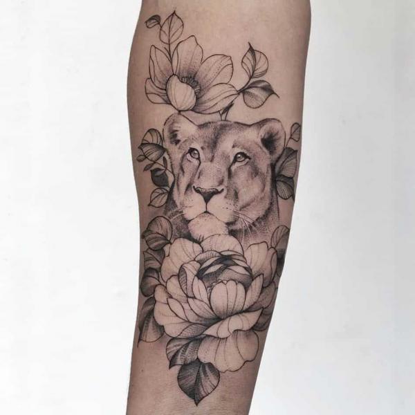 Lioness and flower tattoo