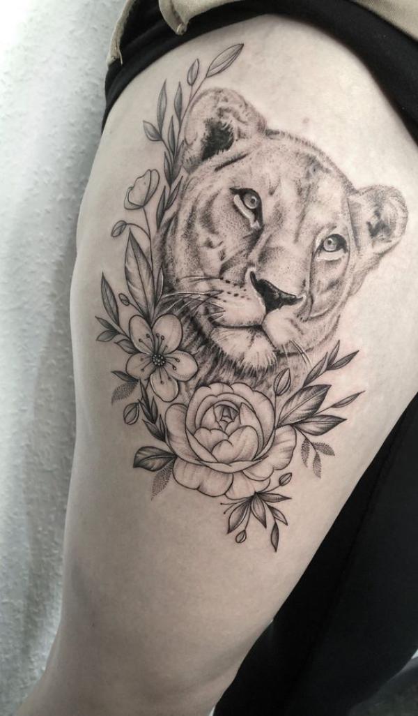 Lioness and rose thigh tattoo