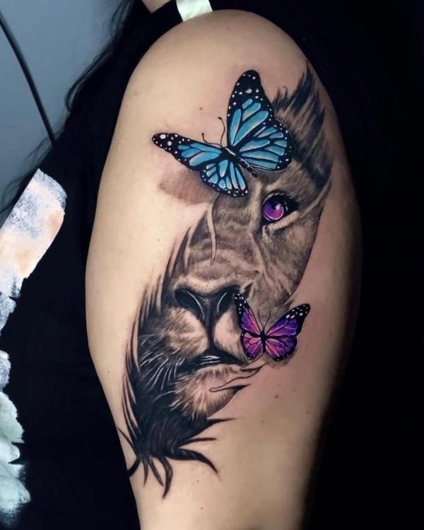 Lioness face with butterfly and purple eye tattoo