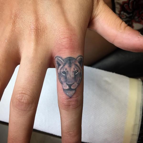 Lioness head finger tattoo realistic