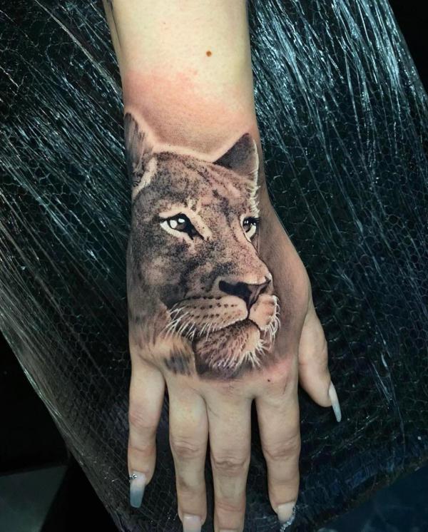 Lioness head hand tattoo realistic