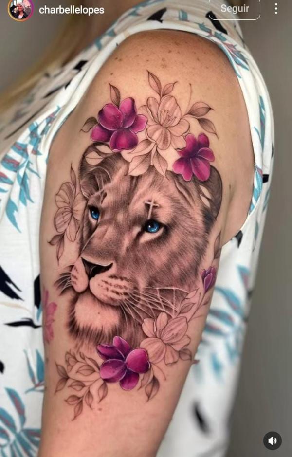 Lioness head with flowers half sleeve tattoo