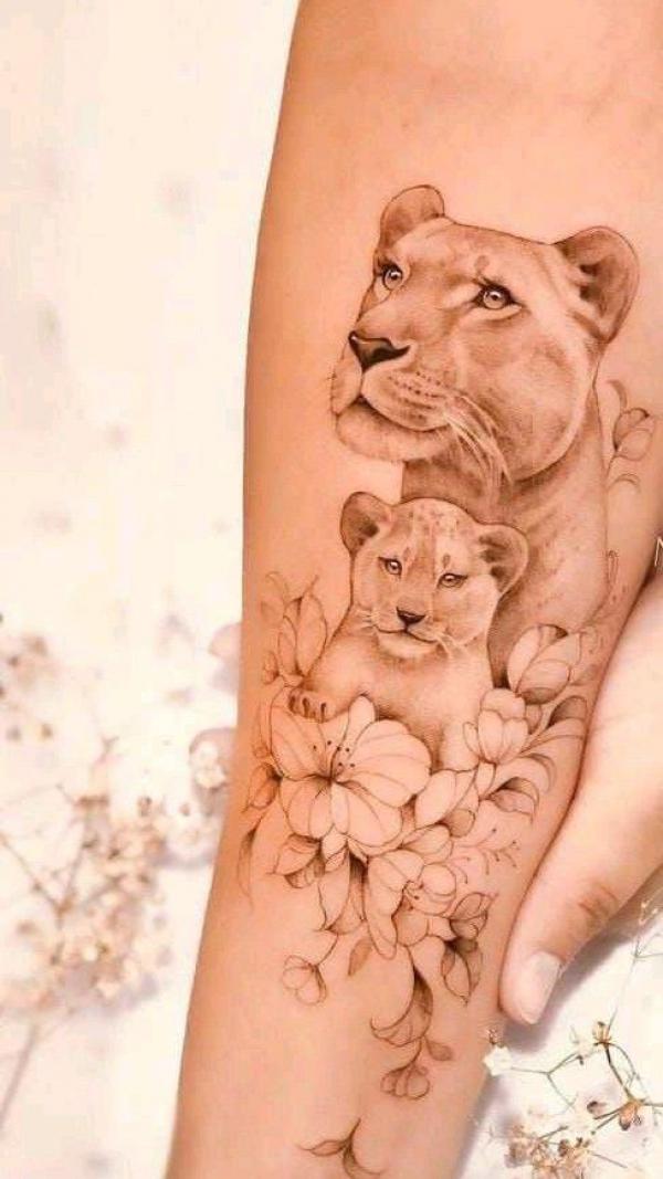 Lioness with cub tattoo on forearm