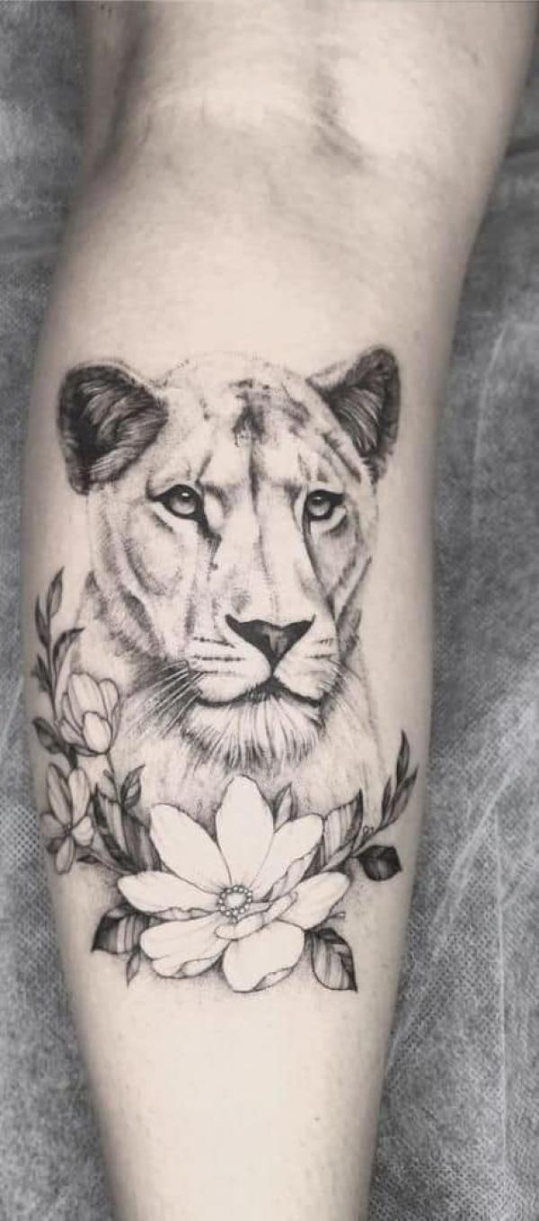 Lioness with flower calf tattoo