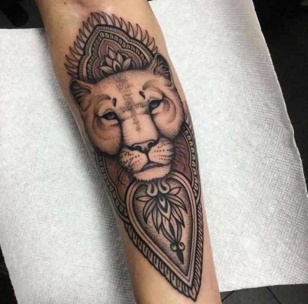 Mandala and lioness forearm tattoo