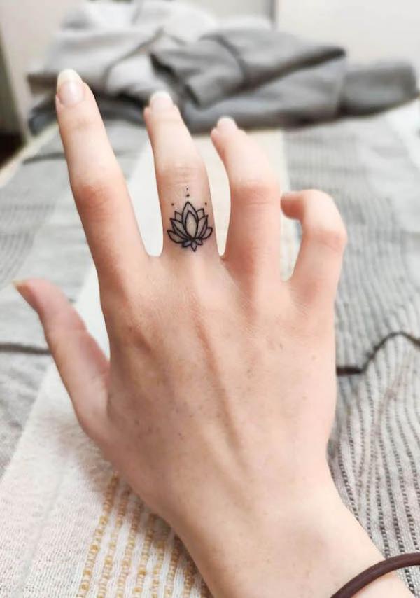 Mandala lotus flower tattoo on middle finger