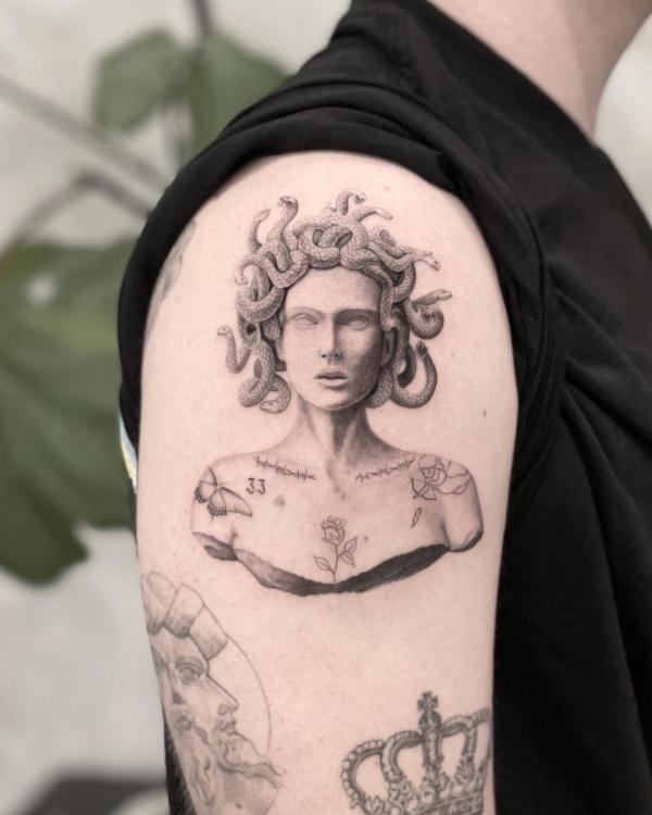 Medusa statue upper arm tattoo 1