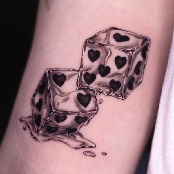 Melted dices with hearts tattoo