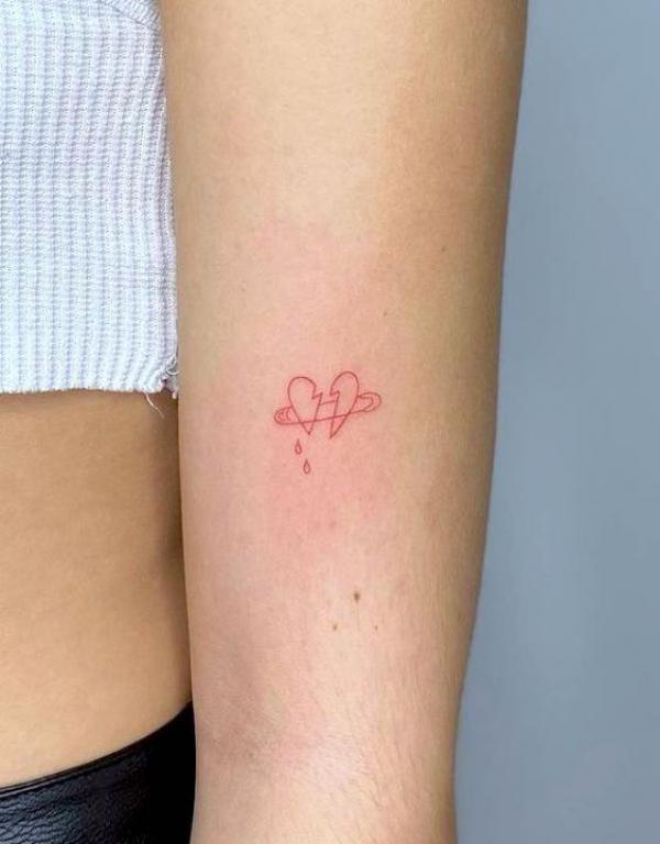 Minimalist broken heart with safety pin tattoo