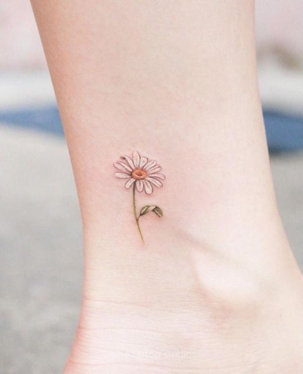 Minimalist daisy ankle tattoo