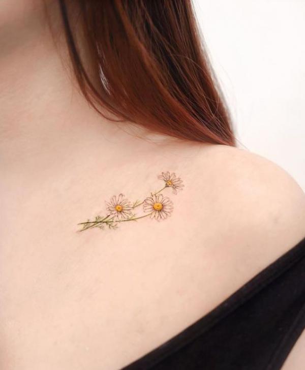 Minimalist daisy flower clavicle tattoo