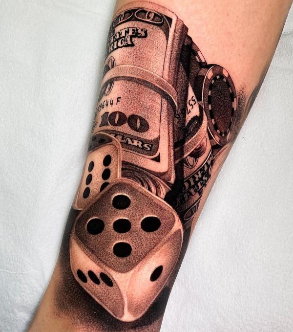Money and dice tattoo forearm