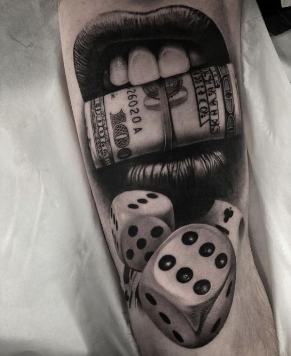 Money in mouth with dices tattoo