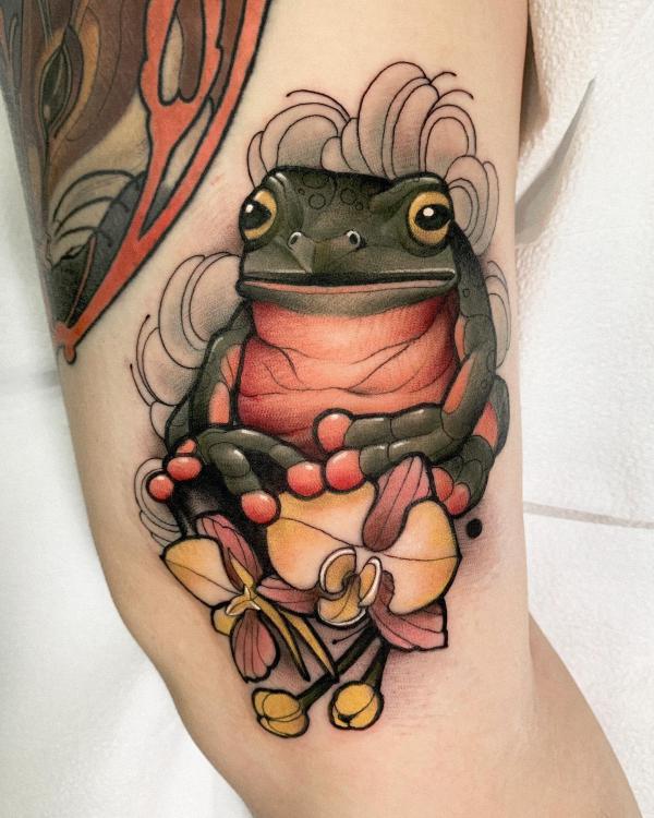 Neo traditional frog tattoo on upper arm