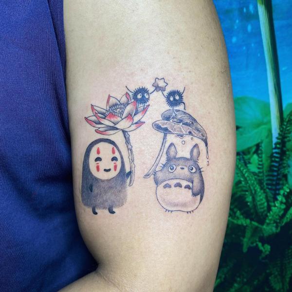 No Face and Totoro holding lotus and leaf tattoo