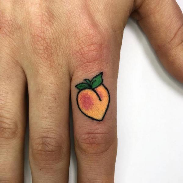 Peach finger tattoo
