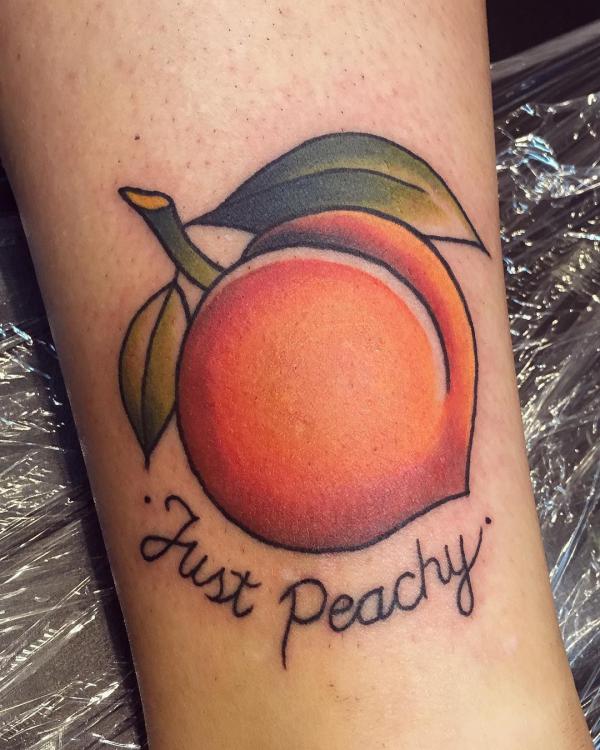 Peach tattoo with phrase Just peachy