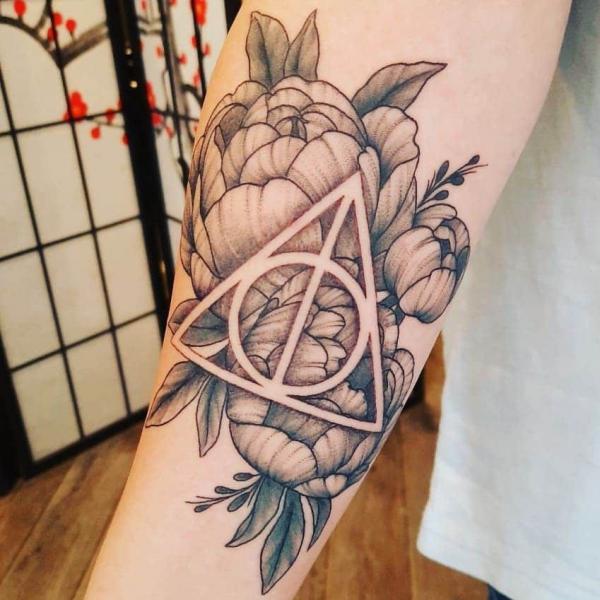 Peonies and negative space deathly hallows tattoo