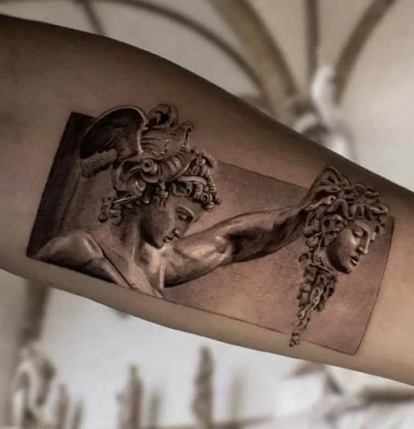 Perseus holding Medusa head upper arm tattoo 1