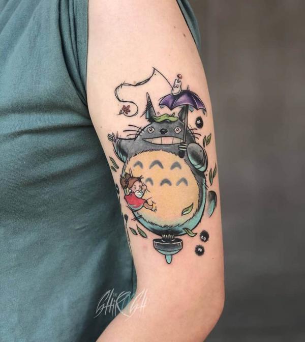 Playful Totoro upper arm tattoo