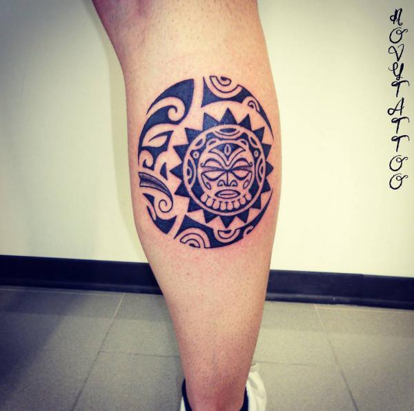 Polynesian tribal sun and moon tattoo on calf