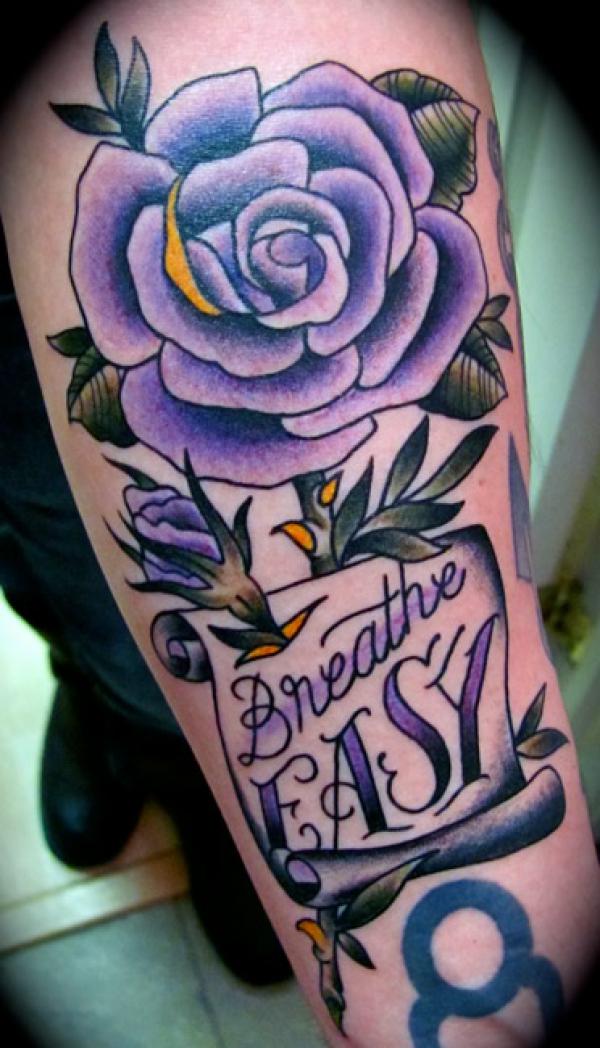 Purple rose with banner bearing words Breathe Easy