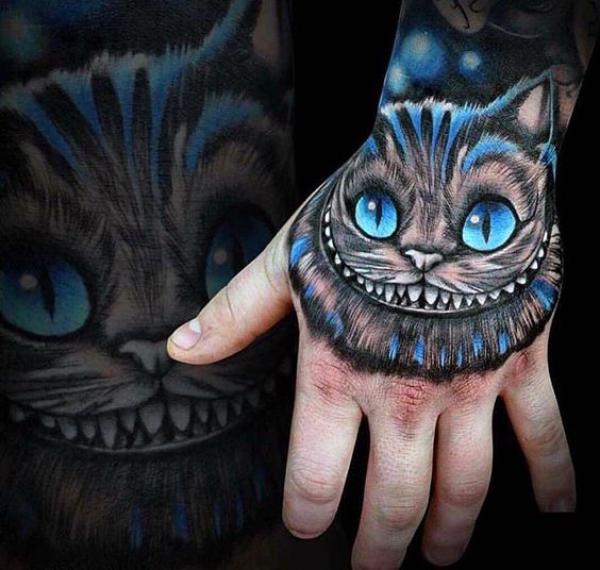 Realistic Cheshire Cat hand tattoo