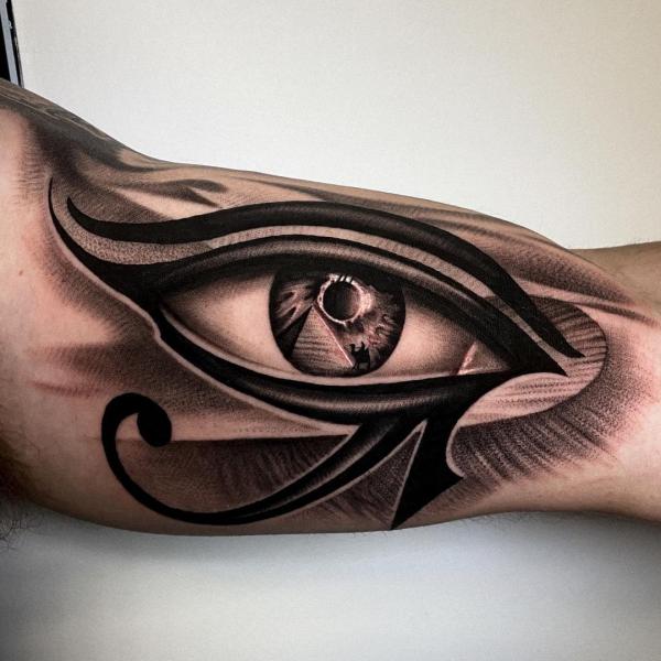 Realistic Eye of Ra tattoo on inner upper arm