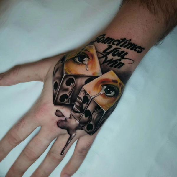 Realistic dices with eye tattoo hand