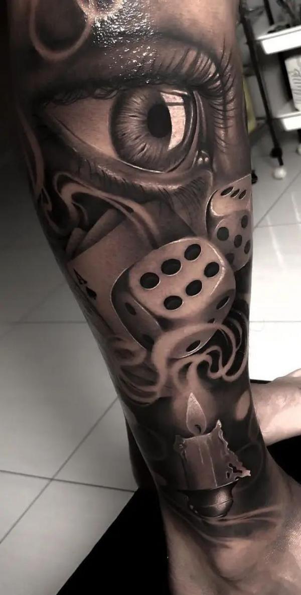 Realistic eye and dice and candle with smoke tattoo