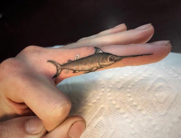 Realistic fish finger tattoo
