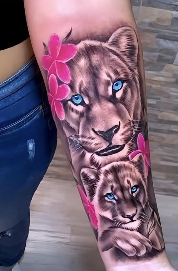 Realistic lioness and cub with Plumeria flowers forearm tattoo