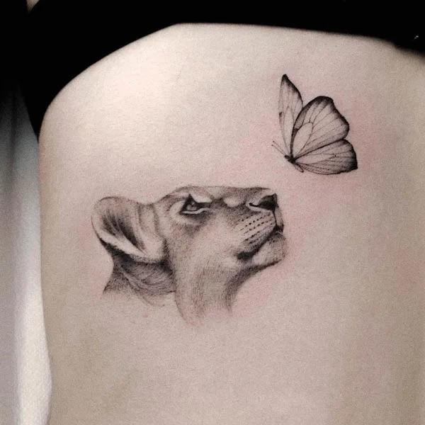 Realistic lioness head and butterfly tattoo black and grey