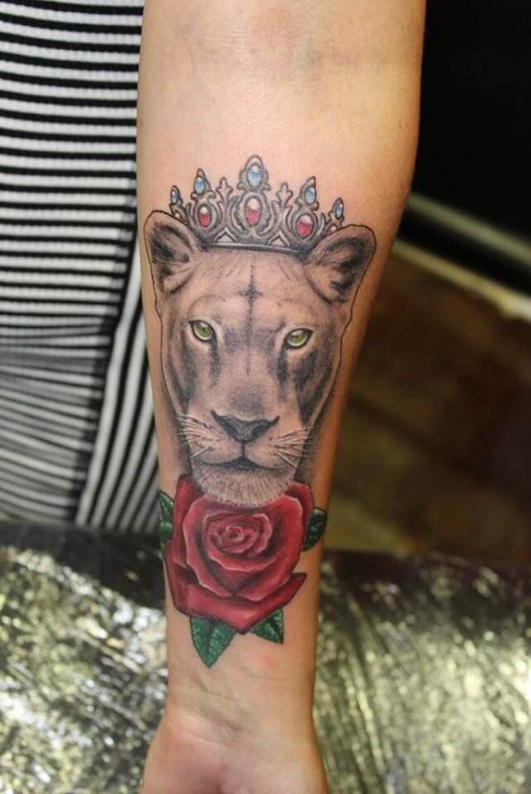 Realistic lioness queen with rose tattoo